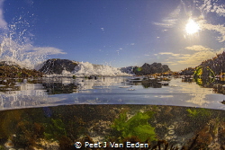 Breaking waves filling a rockpool in the ongoing cycle of... by Peet J Van Eeden 